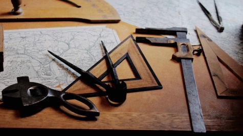 Picture of tools including a drawing compass, a wrench, and angle ruler and more.